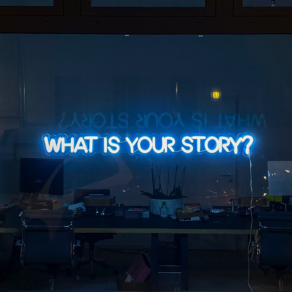pr-intro-photo Image of a neon sign displaying the words what is your story